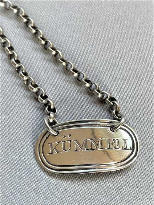 fig 1. A desirable silver 'Kummell' tot label