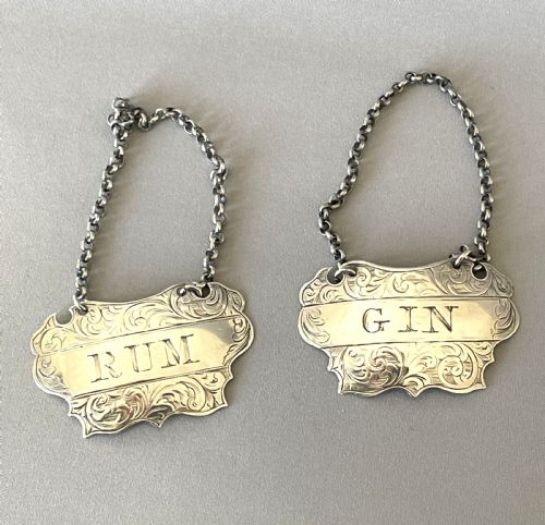 A Desirable Pair of Victorian Silver Rum & Gin Decanter Labels
