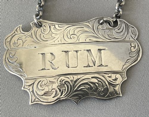 fig 1. A desirable pair of Victorian silver Rum & Gin decanter labels
