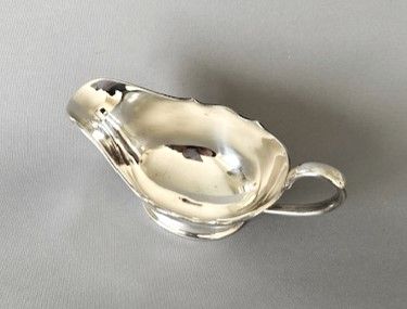 fig 1. A small silver sauce boat by Harrods Ltd.