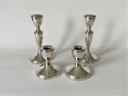 An Unusual Set of 4 Hallmarked Silver Candlesticks