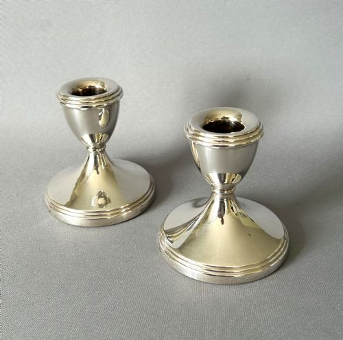 A Charming Pair of Silver Dwarf Candlesticks