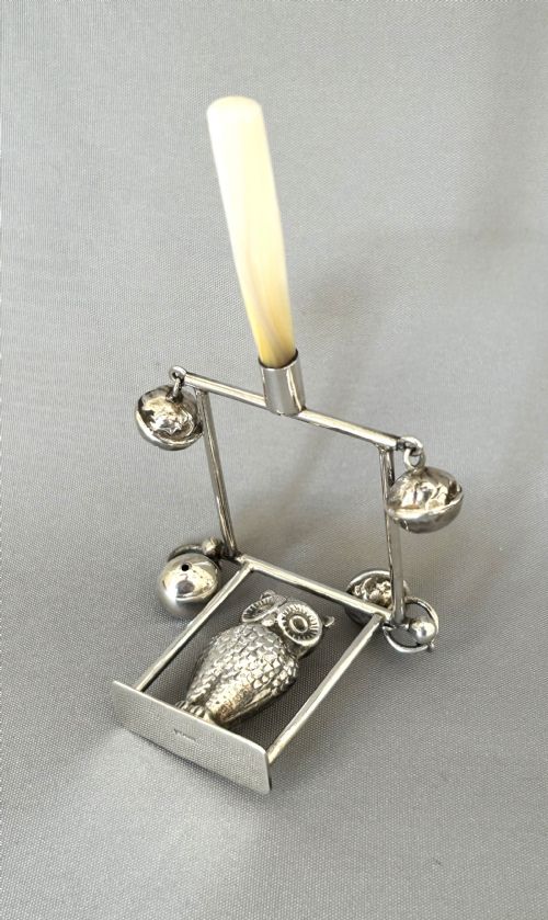 fig 1. A rare owl on a swing silver baby's rattle