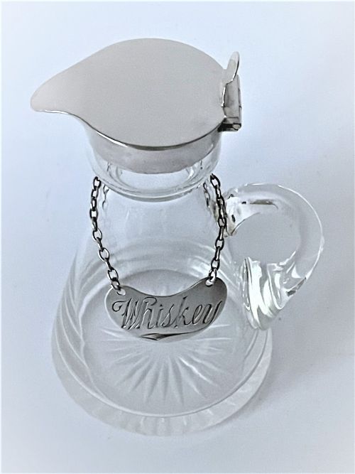 fig 1. A lovely Edwardian silver Whisky tot & label
