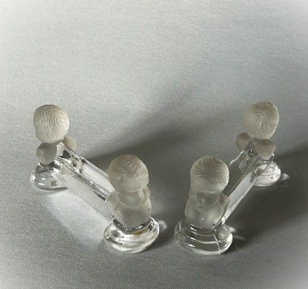 fig 1. A pair of Baccarat glass knife/spoon rests featuring infant Napolean 