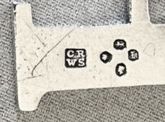 fig 1. An early Victorian silver decanter label designed as the letter P on a silver chain.