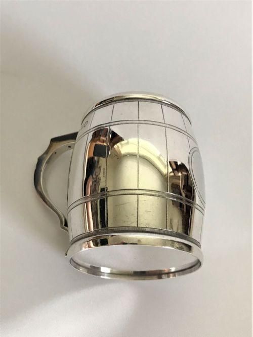 fig 1. A Victorian sterling silver mug shaped like a wooden barrel, complete with engraved stave details and an angular handle.