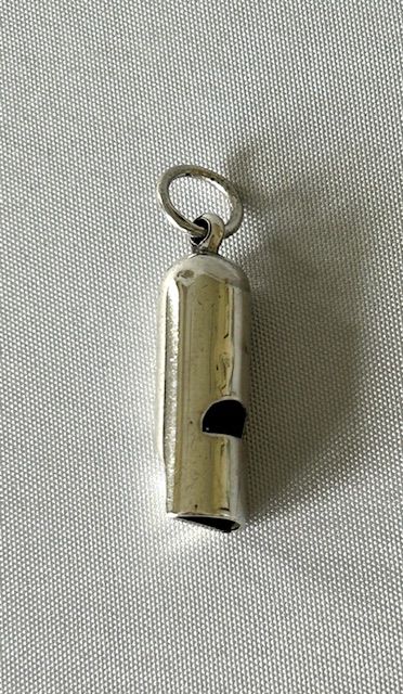 fig 1. A small cylindrical Victorian silver dog whistle with a suspended loop ring attached to the rounded cap.