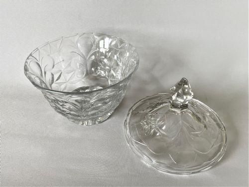 fig 1. A clear Georgian cut glass butter dish featuring a fitted lid topped with a pointed finial and intricate geometric facet cutting.