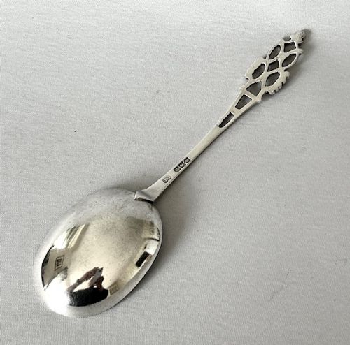 Late Victorian silver serving spoon featuring a polished oval bowl and an openwork pierced handle. View II