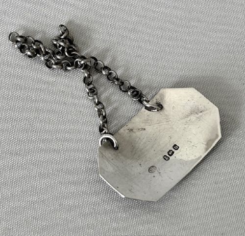 An octagonal Georgian sterling silver decanter label engraved with the word PORT, featuring a reeded border and chain. View III