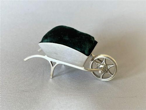 A MOST UNUSUAL EDWARDIAN SILVER NOVELTY WHEELBARROW PIN CUSHION