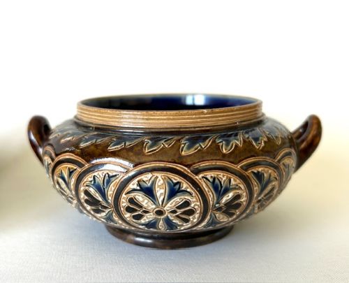 fig 1. A Victorian Doulton Lambeth stoneware cream jug and open bowl featuring brown and cobalt blue glazes with relief foliate pattern decoration.