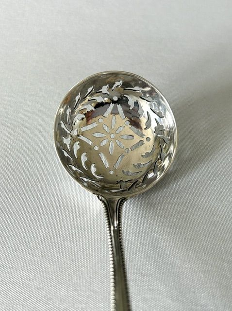 fig 1. A handsome 18th Century silver sifter spoon with incuse duty mark