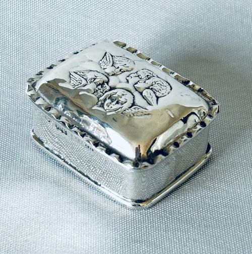 A CHARMING EDWARDIAN SILVER REYNOLDS ANGELS PILL BOX