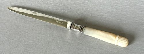 A LOVELY SILVER MOUNTED MOTHEROFPEARL LETTER OPENER
