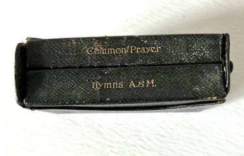 fig 1. An Edwardian black leather prayer and hymn book duo housed in an embossed sterling silver case featuring cherub heads and scrolling foliage.