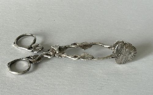 A pair of Victorian cast silver tea tongs designed with naturalistic vine branch handles, leaf motifs, and leaf-shaped grips. View III