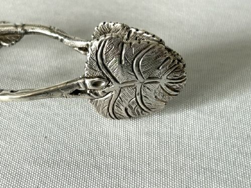 A pair of Victorian cast silver tea tongs designed with naturalistic vine branch handles, leaf motifs, and leaf-shaped grips. View IV