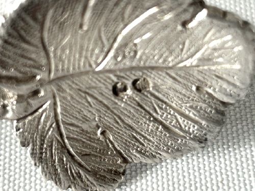 A pair of Victorian cast silver tea tongs designed with naturalistic vine branch handles, leaf motifs, and leaf-shaped grips. View VII