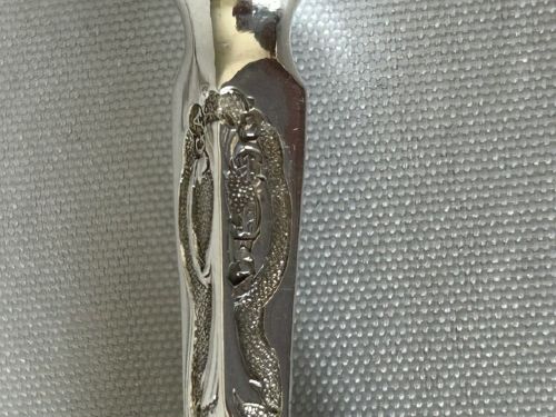 A Victorian silver dessert knife and fork featuring engraved scrollwork on the blade and tines with polished rectangular dark brown agate handles. View V