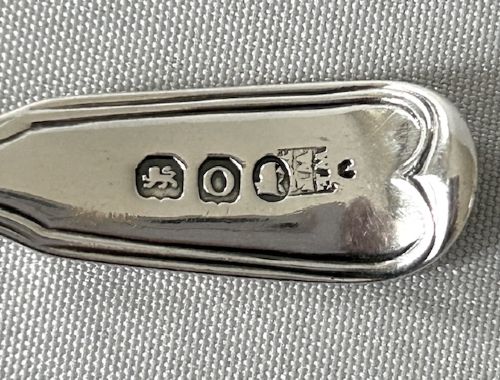 A Georgian sterling silver spice sifting spoon featuring a circular pierced bowl and a long moulded handle. View III