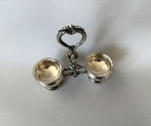 An antique French silver double condiment stand with a central scroll handle and two circular glass-lined holders. View IV