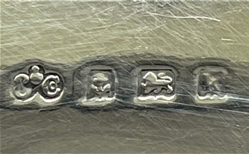 A rectangular Edwardian sterling silver wallet and stamp case displaying visible British silver hallmarks on its smooth metallic exterior. View III