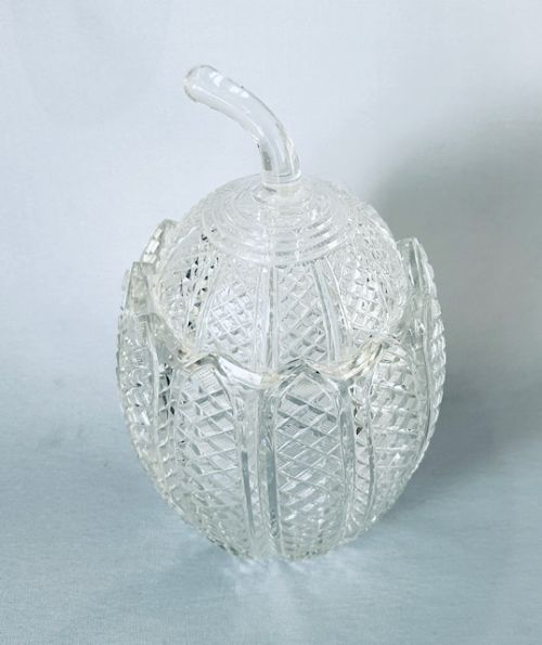 fig 1. A Georgian clear cut-glass novelty biscuit barrel shaped like a melon with diamond cutting and a curved glass stem lid.