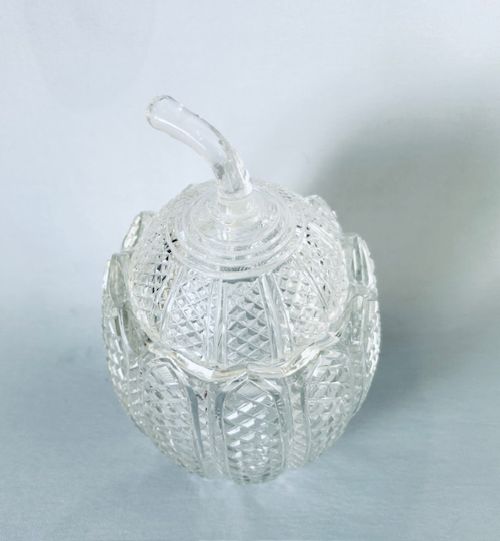 A Georgian clear cut-glass novelty biscuit barrel shaped like a melon with diamond cutting and a curved glass stem lid. View V
