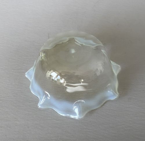A small yellowish-green vaseline glass finger bowl featuring a flared ruffled rim with white opalescent shading. View V