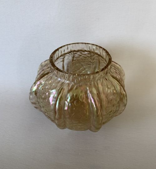 fig 1. An Art Nouveau iridescent amber glass rose bowl featuring a lobed body and a hammered martele pattern finish.