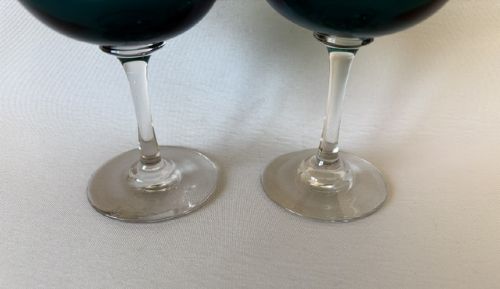 A pair of Victorian champagne coupes featuring deep teal green shallow bowls resting on clear glass stems and circular bases. View III