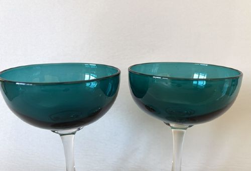 A pair of Victorian champagne coupes featuring deep teal green shallow bowls resting on clear glass stems and circular bases. View IV