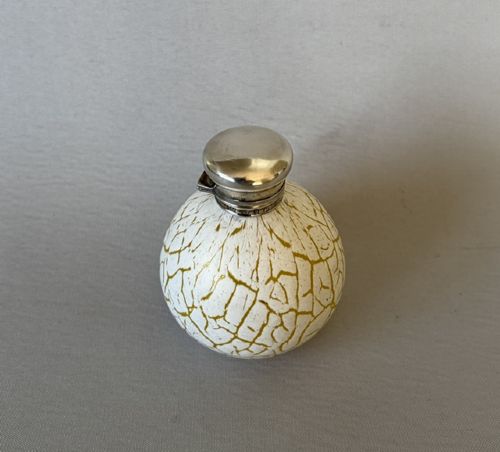 fig 1. A spherical Victorian crackle glass scent bottle featuring a silver hallmarked hinged cap.