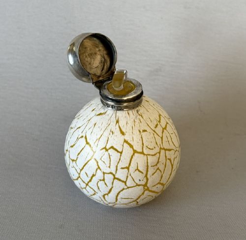 A spherical Victorian crackle glass scent bottle featuring a silver hallmarked hinged cap. View IV