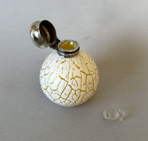 A spherical Victorian crackle glass scent bottle featuring a silver hallmarked hinged cap. View V