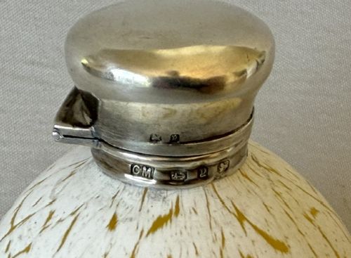 A spherical Victorian crackle glass scent bottle featuring a silver hallmarked hinged cap. View VI