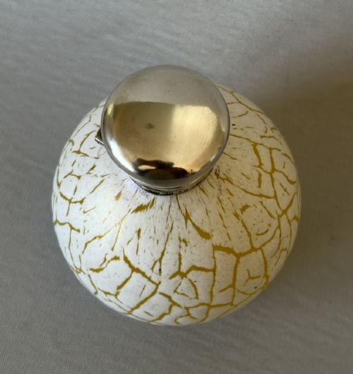A spherical Victorian crackle glass scent bottle featuring a silver hallmarked hinged cap. View VII