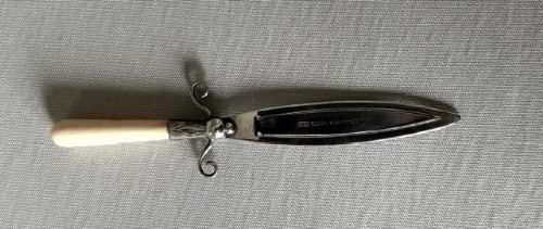 fig 1. An Edwardian silver bookmark in the shape of a dagger featuring a hallmarked blade, scroll crossguard, and cream bone handle.