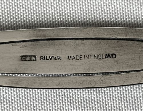 An Edwardian silver bookmark in the shape of a dagger featuring a hallmarked blade, scroll crossguard, and cream bone handle. View III