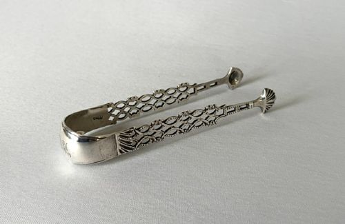 A rare pair of 18th Century cast Irish silver tongs