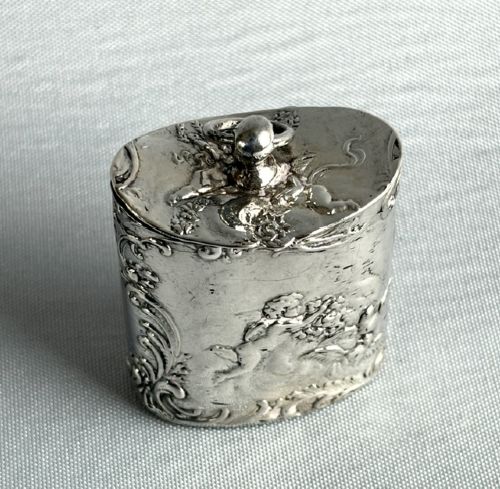 fig 1. An early nineteenth-century Dutch silver miniature tea caddy featuring relief repousse scenes of classical figures on an oval body with a fitted lid.