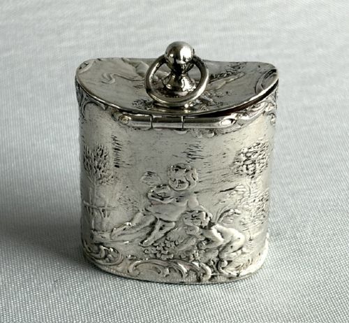An early nineteenth-century Dutch silver miniature tea caddy featuring relief repousse scenes of classical figures on an oval body with a fitted lid. View III