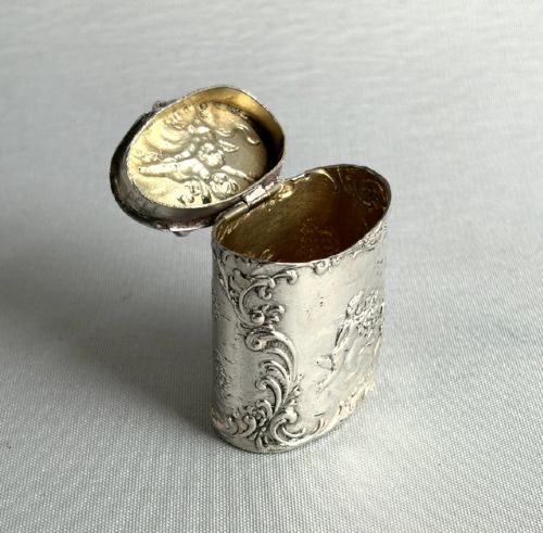 An early nineteenth-century Dutch silver miniature tea caddy featuring relief repousse scenes of classical figures on an oval body with a fitted lid. View VII