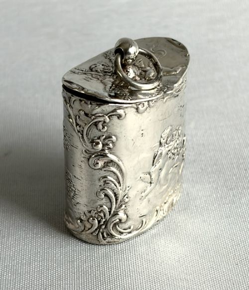 An early nineteenth-century Dutch silver miniature tea caddy featuring relief repousse scenes of classical figures on an oval body with a fitted lid. View IX
