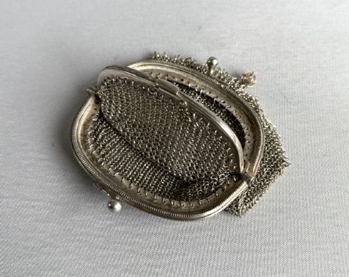 An antique French silver chain mail coin purse featuring a beaded kiss-lock clasp frame and suspension ring. View III