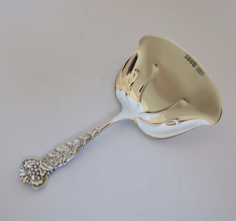 An extremely rare Tiffany silver bonbon shovel in holly & mistletoe pattern.