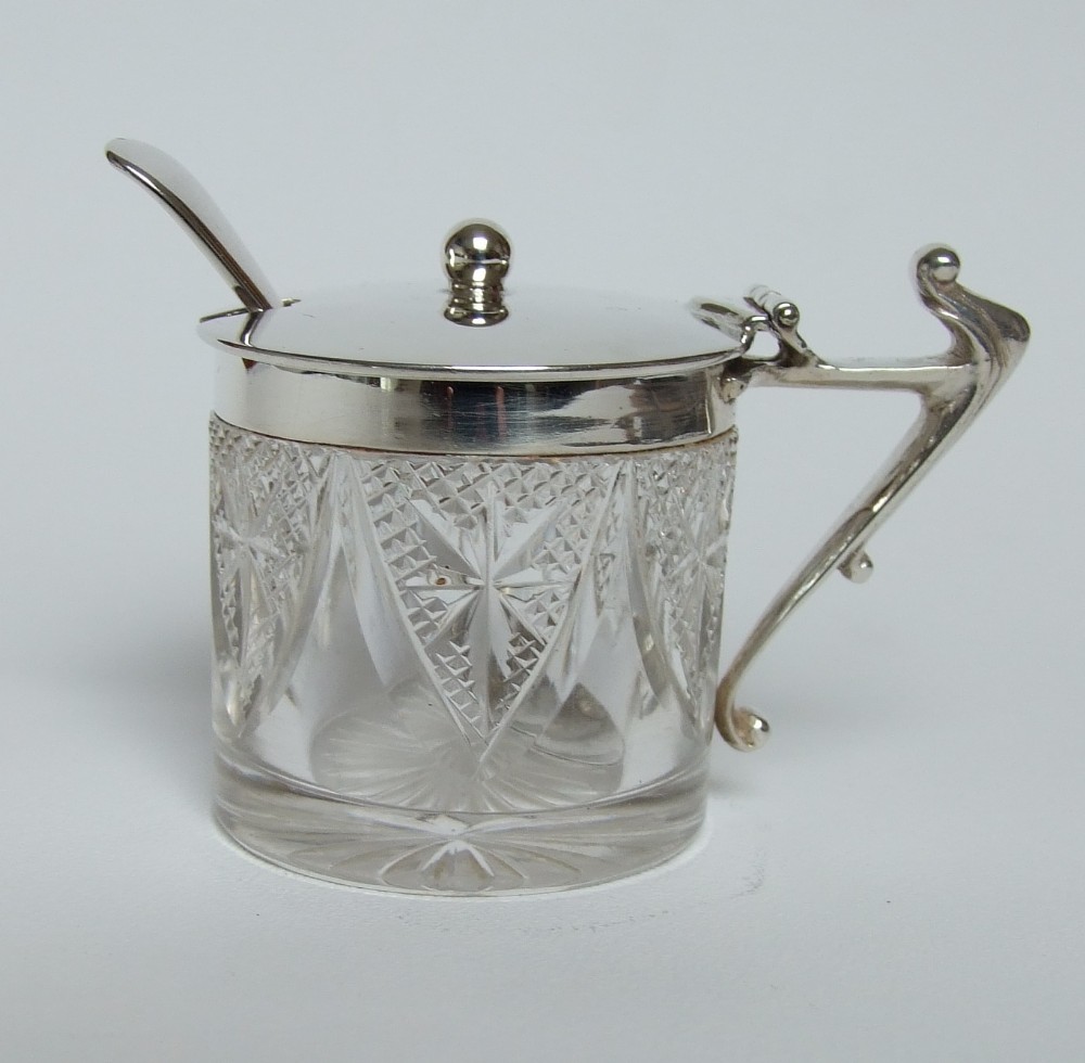 An unusual Edwardian silver mounted mustard pot and spoon.