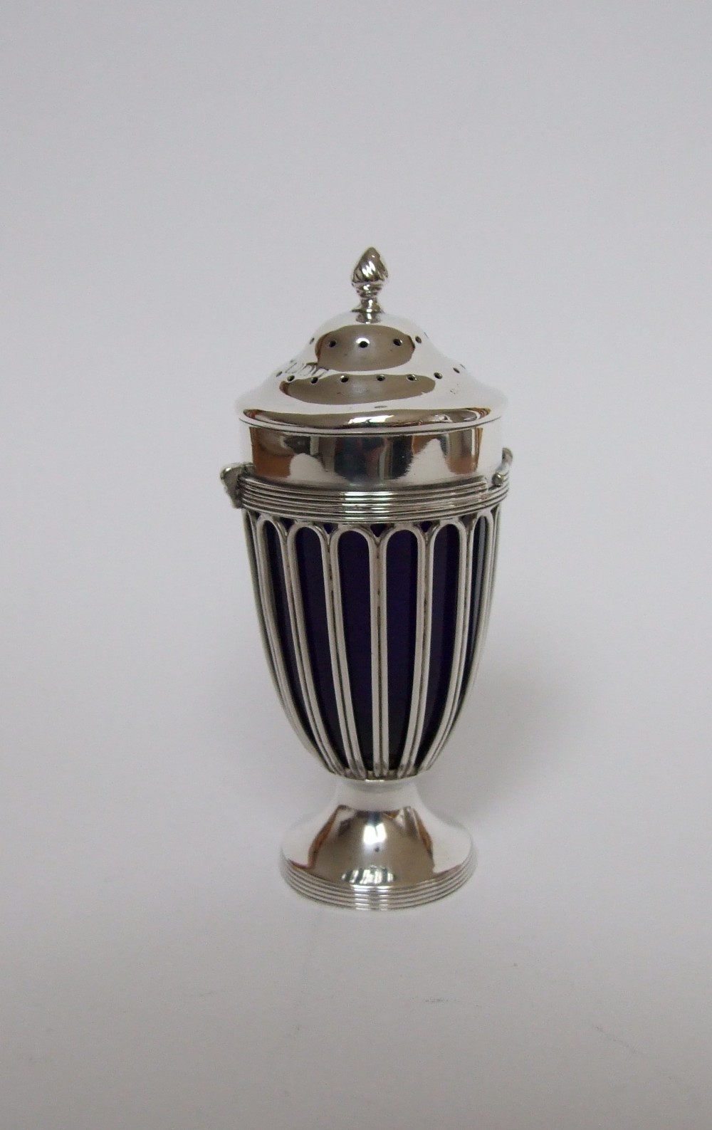 An elegant Victorian silver wirework pepper pot.
